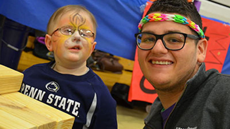 Ellman spends time playing with Penn State Altoona's THON child, Collin Kratzer, during the college's 12-hour Dance Marathon event