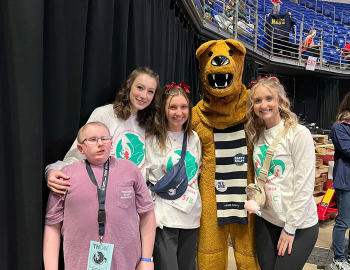 Neya, Caroline, Taylor, and the Nittany Lion with Neya’s younger brother, Collin, a cancer survivor and Four Diamonds child