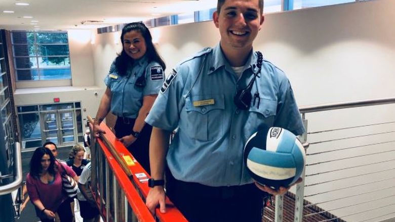Student auxiliary officers retrieve volleyball
