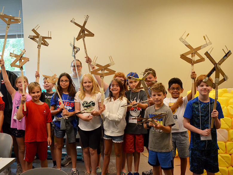 A group of kids showing off their projects at Kids' College