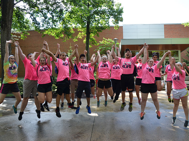 Orientation Leaders jump for a photo on move in day